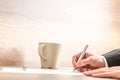 Businessman writing with a pen on a paper sheet Royalty Free Stock Photo