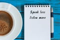 Businessman writing SPEAK LESS LISTEN MORE on notepad near morning coffee cup. With empty space for text