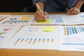 Businessman writing on sticky note on business document. paper r Royalty Free Stock Photo