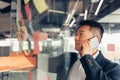 Businessman writing on sticky notes on glass wall while working in modern office Royalty Free Stock Photo