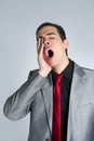 Businessman yawn boring on gray background Royalty Free Stock Photo