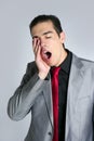 Businessman yawn boring on gray background Royalty Free Stock Photo