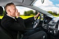 Businessman yawning while driving car Royalty Free Stock Photo