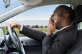 Businessman Yawning While Driving Car Royalty Free Stock Photo
