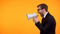 Businessman yelling in megaphone, announcement of breaking news, place for text