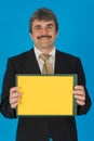 Businessman with yellow sign Royalty Free Stock Photo