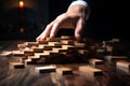 Businessmans hands prevent domino fall, illustrating risk control and planning