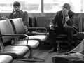 Businessmen in airport lounge waiting for fllight, horizontal Royalty Free Stock Photo