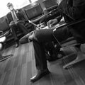 Businessmen in airport lounge waiting for fllight, vertical Royalty Free Stock Photo