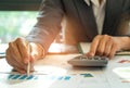 Businessmen are analyzing graphs and using calculator,Businessman has a pen in his hand, points to a graph and is using Royalty Free Stock Photo