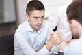 Businessmen arm wrestling in office Royalty Free Stock Photo