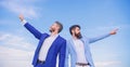 Businessmen bearded faces stand back to back sky background. Men formal suit managers pointing at opposite directions Royalty Free Stock Photo