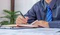 Businessmen bookkeeper hand holding pen doing account for paying tax in working office