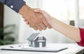 Businessmen and brokers real estate agents shake hand after completing negotiations to buy houses insurance and sign contracts. Royalty Free Stock Photo