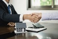 Businessmen and brokers real estate agents shake hands after completing negotiations to buy houses insurance and sign contracts. Royalty Free Stock Photo