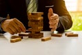 Businessmen build wooden block towers as a symbol of development and planning in business. Strategies for success and planning. Ri