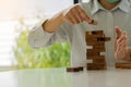 Businessmen build wooden block towers as a symbol of development and planning in business. Strategies for success and planning. Ri