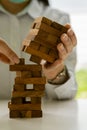 Businessmen build wooden block towers as a symbol of development and planning in business. Strategies for success and planning. Ri