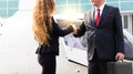 Businessmen and business woman making handshake in the city with helicopter background Royalty Free Stock Photo