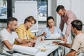 businessmen and businesswoman having meeting at table