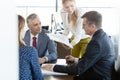 Businessmen and businesswomen in discussion with project in board room Royalty Free Stock Photo