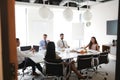 Businessmen And Businesswomen Meeting In Modern Boardroom Over Working Lunch Royalty Free Stock Photo