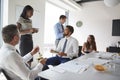 Businessmen And Businesswomen Meeting In Modern Boardroom Over Working Lunch Royalty Free Stock Photo