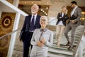 Businessmen and businesswomen walking and taking stairs in an of Royalty Free Stock Photo