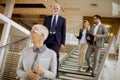 Businessmen and businesswomen walking and taking stairs in an of Royalty Free Stock Photo