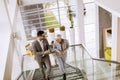 Businessmen and businesswomen walking and taking stairs in an of Royalty Free Stock Photo