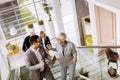 Businessmen and businesswomen walking and taking stairs in an of Royalty Free Stock Photo