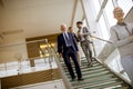 Businessmen and businesswomen walking and taking stairs in an of Royalty Free Stock Photo