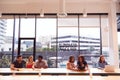 Businessmen And Businesswomen Working In Shared Open Plan Office Workspace