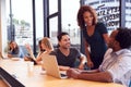 Businessmen And Businesswomen Working In Shared Open Plan Office Workspace