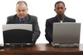 Businessmen At Desk With Laptops