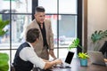 Businessmen discussing at office talk about work for success with laptop on table.