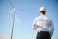 Businessmen engineering standing handsome smile front of turbine looking away