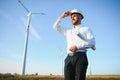 Businessmen engineering standing handsome smile front of turbine looking away