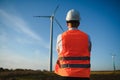 Businessmen engineering standing handsome smile front of turbine looking away