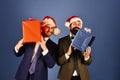 Businessmen with excited faces hold red and blue present boxes Royalty Free Stock Photo