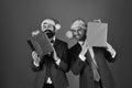 Businessmen with excited faces hold red and blue present boxes Royalty Free Stock Photo