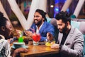 Businessmen Friends having fun at the bar, drinking cocktails. Royalty Free Stock Photo