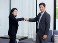 businessmen giving fist bump after business achievement in meeting room.