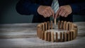 Businessmen grasp the circular wood blocks fall into planning and strategies that are vulnerable to business and defense options. Royalty Free Stock Photo