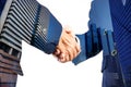 Businessmen hand shake together with Modern City building scene