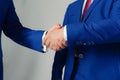 Businessmen hands in formal suits greet each other. Company leaders