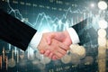 Businessmen handshake on blurry  forex chart grid Royalty Free Stock Photo
