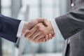 Building a strong business network. two businessmen shaking hands in a modern office. Royalty Free Stock Photo