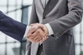 Building a strong business network. two businessmen shaking hands in a modern office. Royalty Free Stock Photo