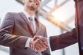 Building a strong business network. two businessmen shaking hands in a modern office. Royalty Free Stock Photo